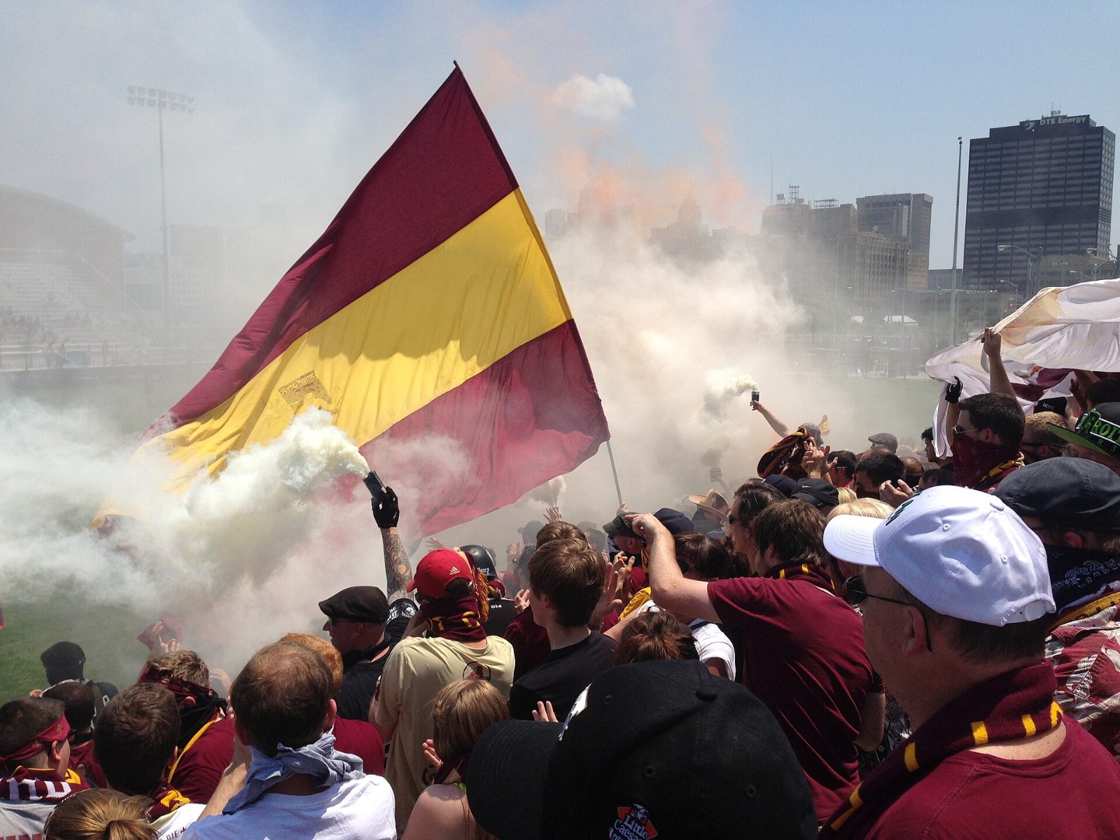 A giant maroon and gold flag over the supporters section in 2013