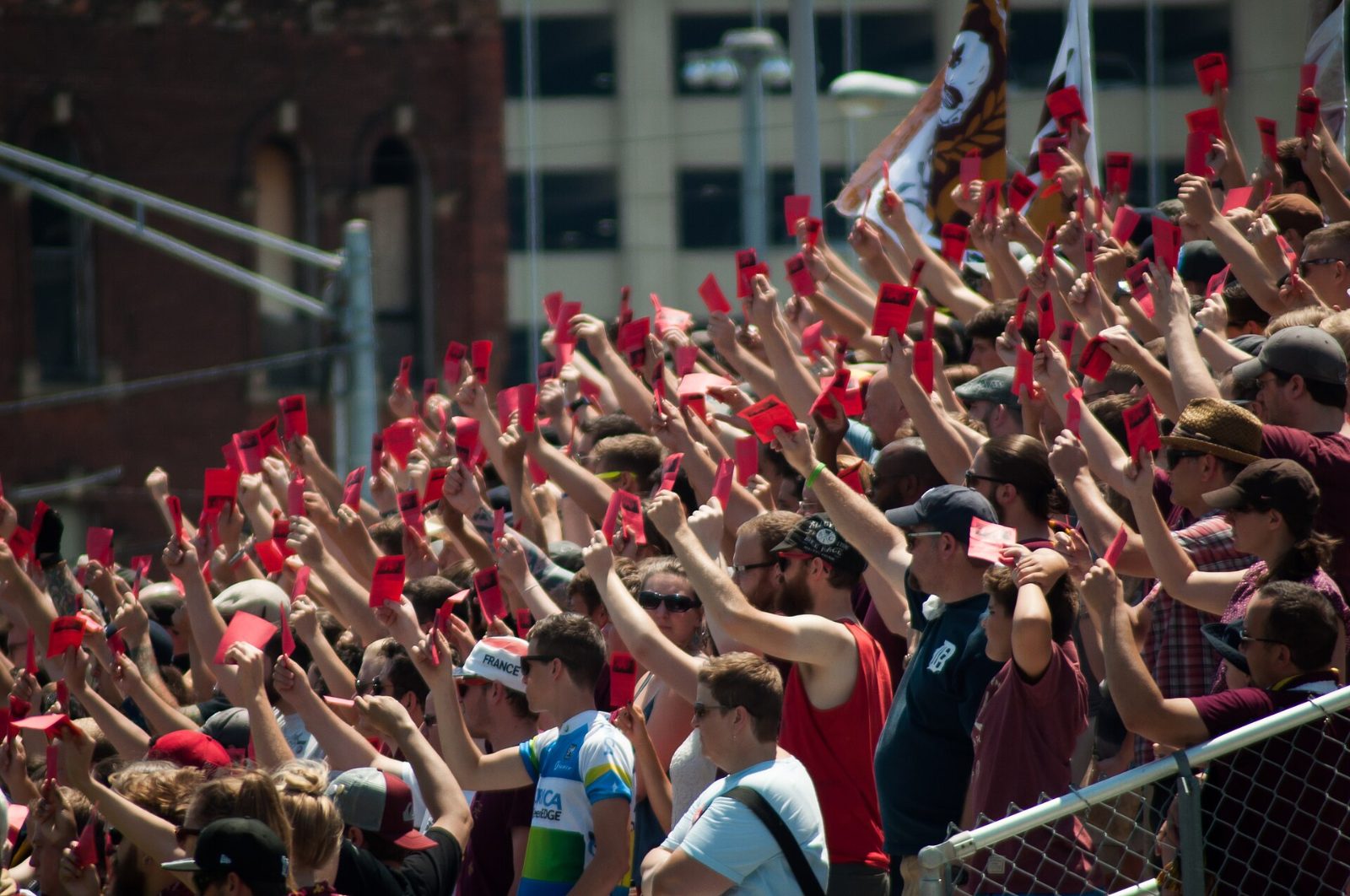 Supporters hold up red cards in a tribute to referee John Bieniewicz